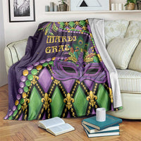 Mardi Gras decorative throw blanket with purple and green fleur-de-lis face mask pattern