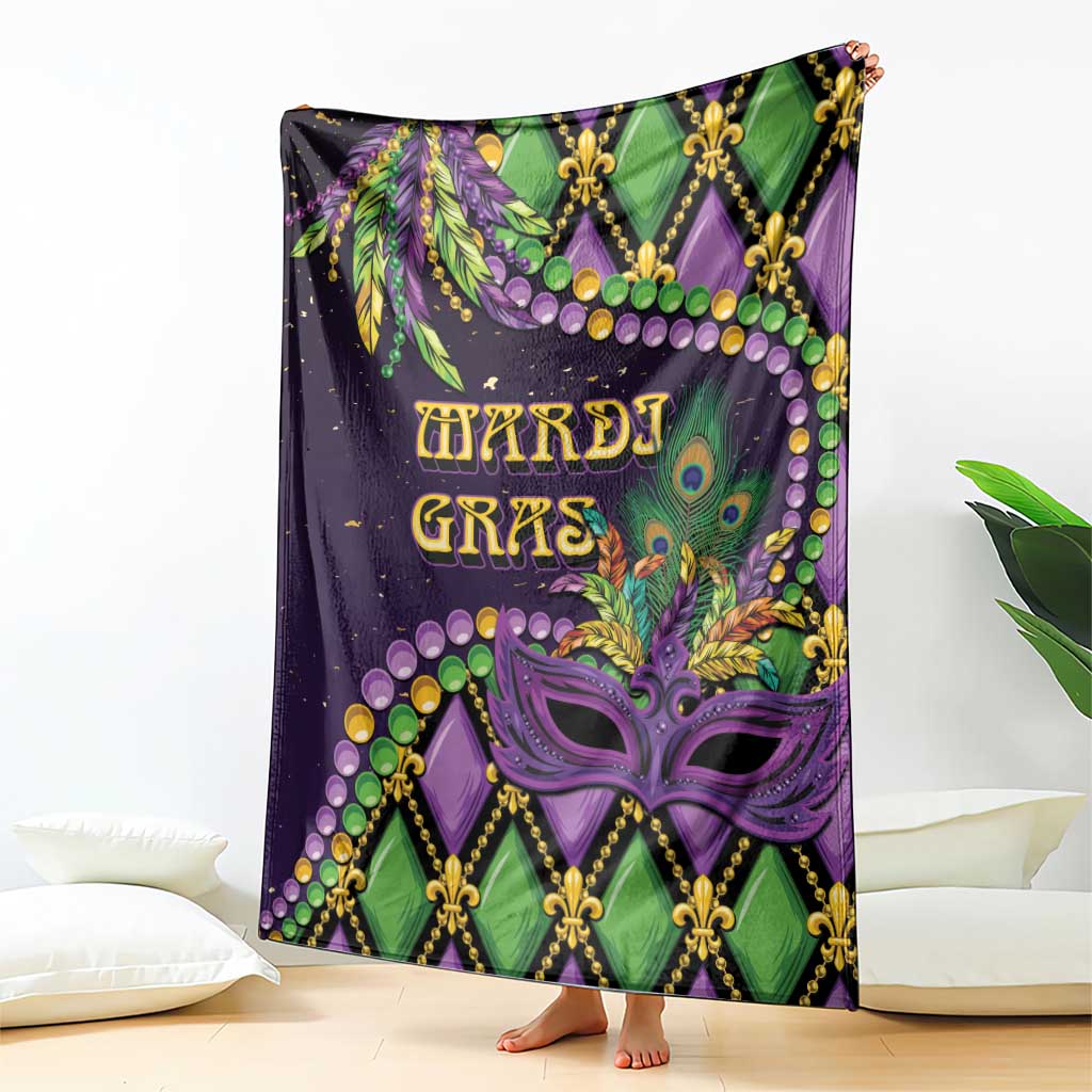 Mardi Gras throw blanket featuring mask and fleur-de-lis motifs in purple and green