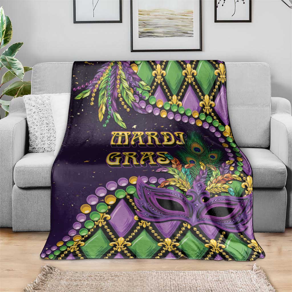 Mardi Gras throw blanket draped on a sofa, purple green mask and fleur-de-lis design