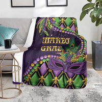 Mardi Gras blanket throw with purple and green mask and fleur-de-lis motifs