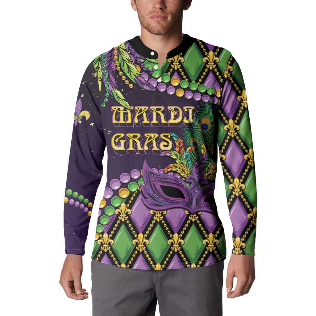 Long-sleeve button-collar sweatshirt on model, purple/green mask and fleur-de-lis print
