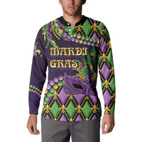 Long-sleeve button-collar sweatshirt on model, purple/green mask and fleur-de-lis print
