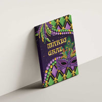 Mardi Gras canvas wall art hanging on wall, purple masquerade mask with “HARDI GRAS” text