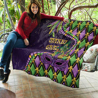 Purple Mardi Gras quilt held on a patio with Mardi Gras text, purple mask, and fleur-de-lis