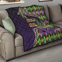 Purple Mardi Gras quilt draped on a sofa with diamond stitching, purple mask, and beads