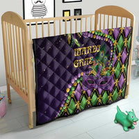 Purple Mardi Gras quilt on a baby bed with Mardi Gras text, purple mask, and green trim