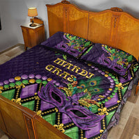 Purple quilt bed set with two pillows, mask and fleur-de-lis motif with green accents