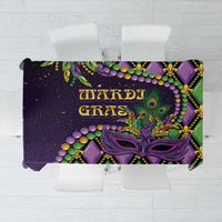 Mardi Gras tablecloth with purple, green, and gold fleur-de-lis mask print