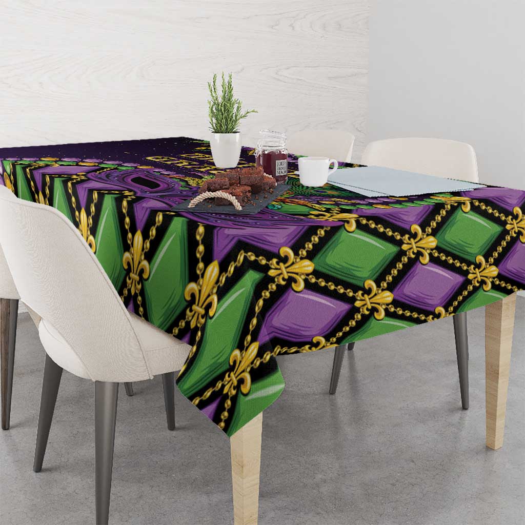 Mardi Gras tablecloth corner view with purple and green fleur-de-lis mask pattern