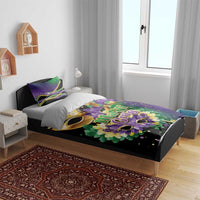 Mardi Gras duvet cover set on bed, featuring gold mask, flowers, and purple accents
