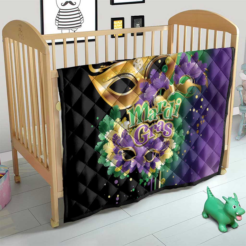 Quilt laid in baby crib, black with purple Mardi Gras feather mask design