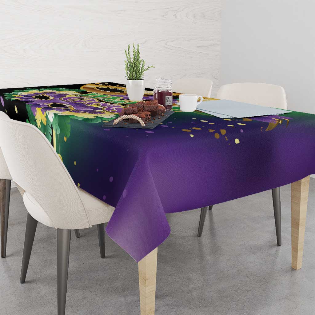 Purple festival tablecloth with green, gold, and purple mask design and dots
