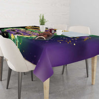 Purple festival tablecloth with green, gold, and purple mask design and dots