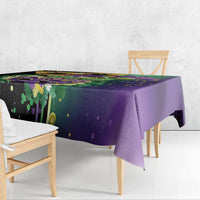 Purple Mardi Gras tablecloth with feathered mask graphic and hanging drape