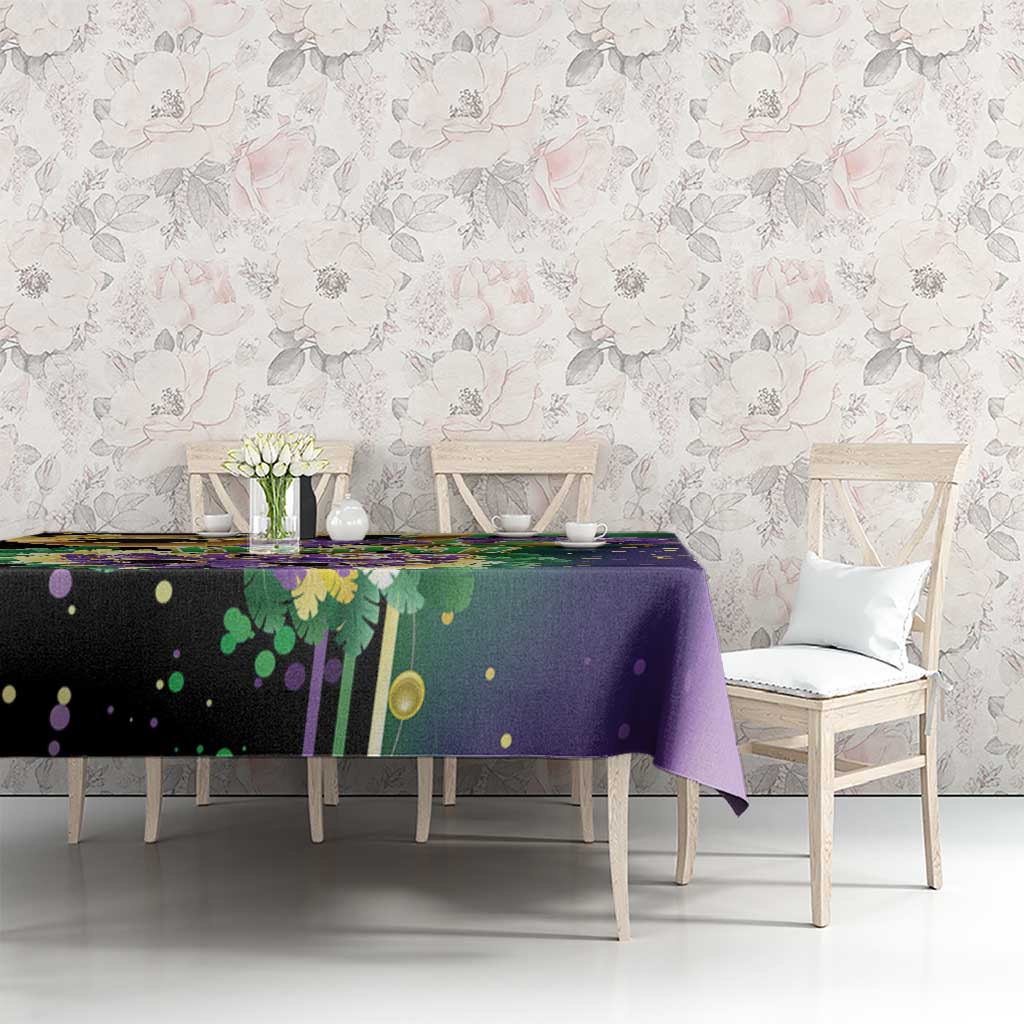 Purple Mardi Gras tablecloth with mask, feathers, and gold dot accents across top