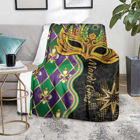 Mardi Gras blanket on sofa seat, gold mask with fleur-de-lis and green purple diamond pattern