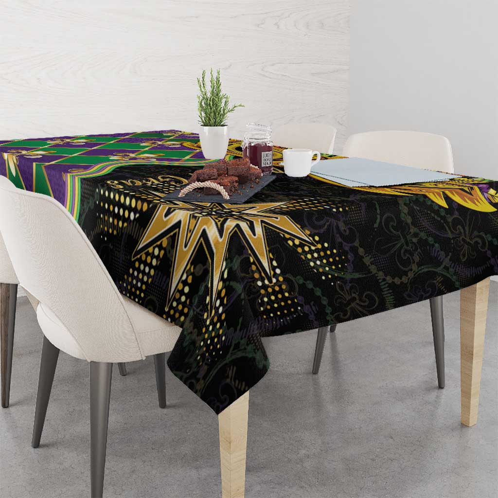 Mardi Gras tablecloth on table corner, black fabric with gold sunburst and colorful stripes