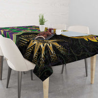 Mardi Gras tablecloth on table corner, black fabric with gold sunburst and colorful stripes