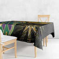 Mardi Gras tablecloth with black background, green and purple diamond panels, overhanging edge