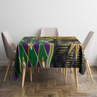 Mardi Gras tablecloth on dining table, black fabric with green, purple, and gold geometric print