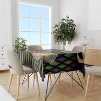 Mardi Gras tablecloth draped on dining table, black purple green vertical stripe pattern