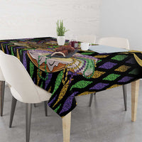Mardi Gras tablecloth with black, purple, and green stripes and fleur-de-lis motifs