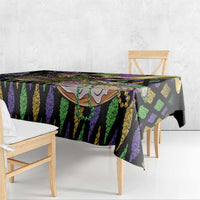Mardi Gras tablecloth over dining table, black purple green vertical stripe design