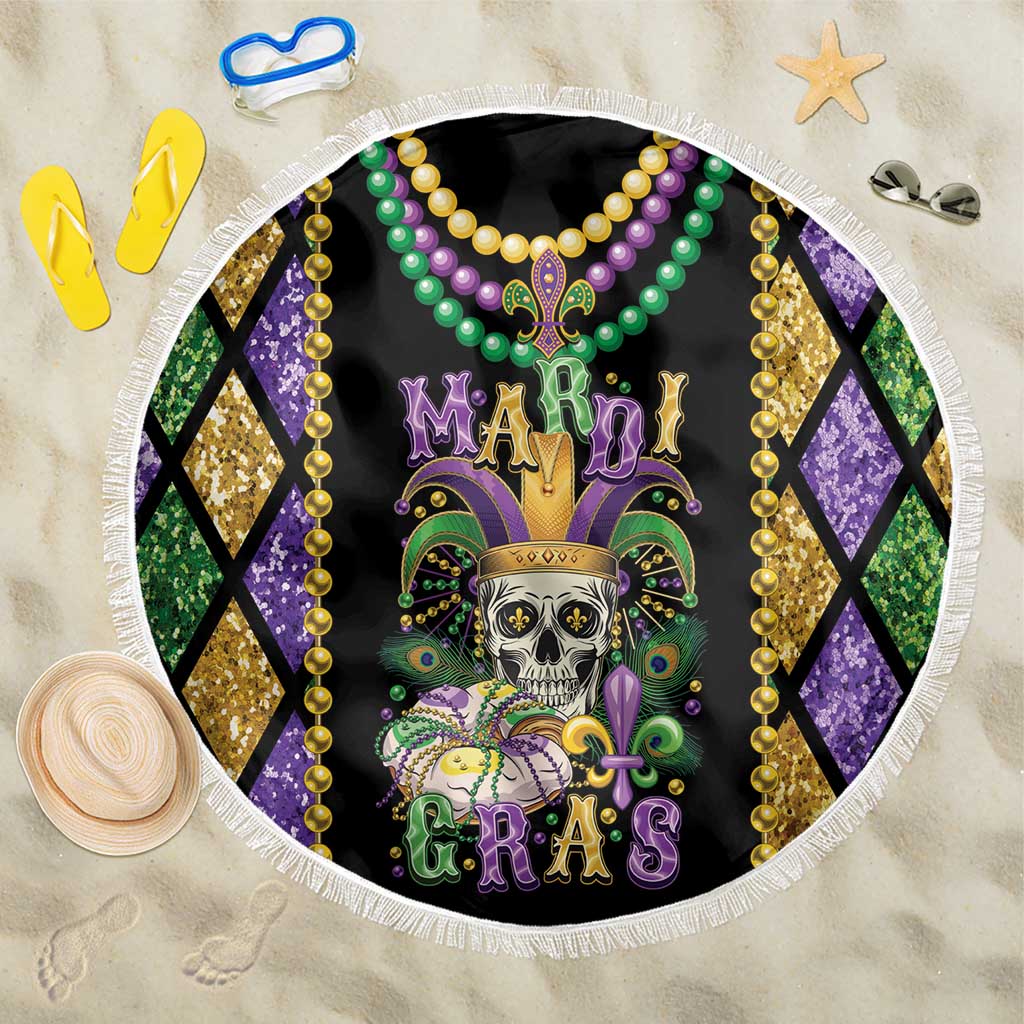 Round Mardi Gras beach blanket with skull graphic, colorful beads, and white fringe border