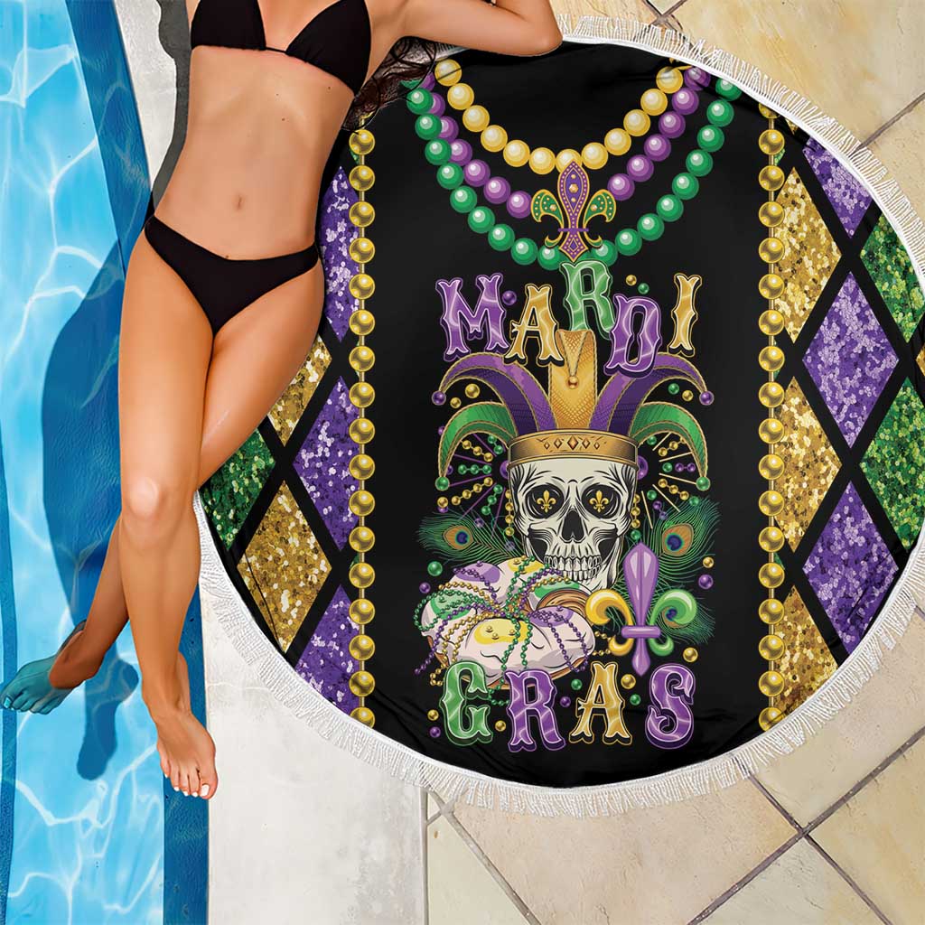 Round beach blanket with black skull graphic, multicolor bead necklace, and white fringe