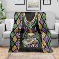 Mardi Gras skull blanket spread on sofa, fleur-de-lis and beads on black fabric