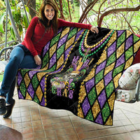 Mardi Gras quilt blanket laid out with purple diamond sides and colorful bead necklace trim