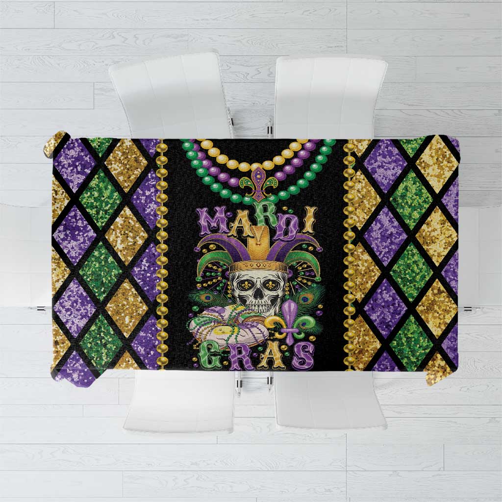 Black skull Mardi Gras tablecloth with purple, green, and gold diamond pattern and bead trim