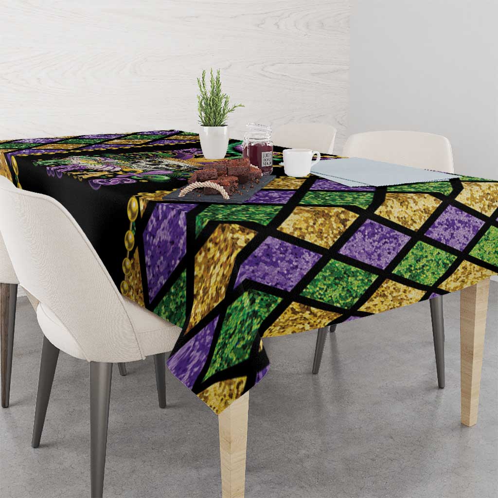 Purple, green, and gold Mardi Gras tablecloth with diamond pattern and decorative bead border
