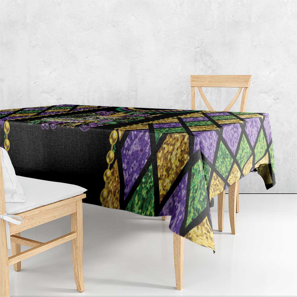 Black Mardi Gras tablecloth with green and gold diamond panels and purple accent edges