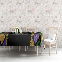 Black Mardi Gras tablecloth with gold and purple diamond sections and beaded trim along edges