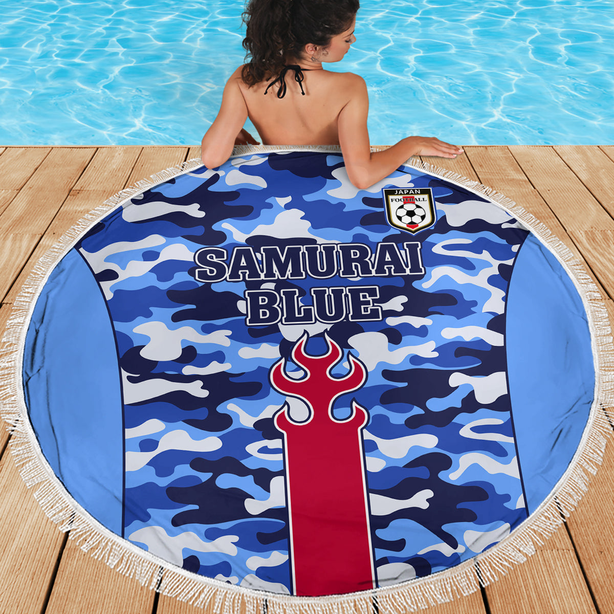 Round blue camouflage beach blanket with fringe edge, “Samurai Blue” and flame emblem.