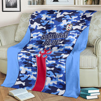 Blue camo football blanket with red torch emblem and Samurai Blue text, draped over chair