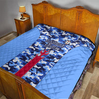 Japan football quilt spread on a bed, blue camouflage with Samurai Blue text and flame emblem