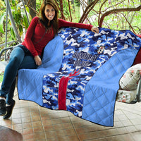 Japan football quilt draped over a sofa, blue camouflage with Samurai Blue lettering and crest badge