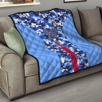 Japan football quilt folded on a couch, blue camo design with Samurai Blue text and flame emblem