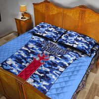 Blue camouflage quilt bed set with “SAMURAI BLUE” text and red crest, on bed with two shams