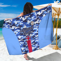 Blue camouflage sarong with “SAMURAI BLUE” print, crest, red vertical stripe, tied wrap