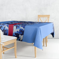 Blue camouflage tablecloth with red stripe draped over table