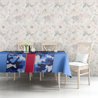 Blue camouflage tablecloth with red stripe and crest at center