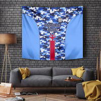 Hanging blue camouflage football tapestry with red flame emblem and crest at center