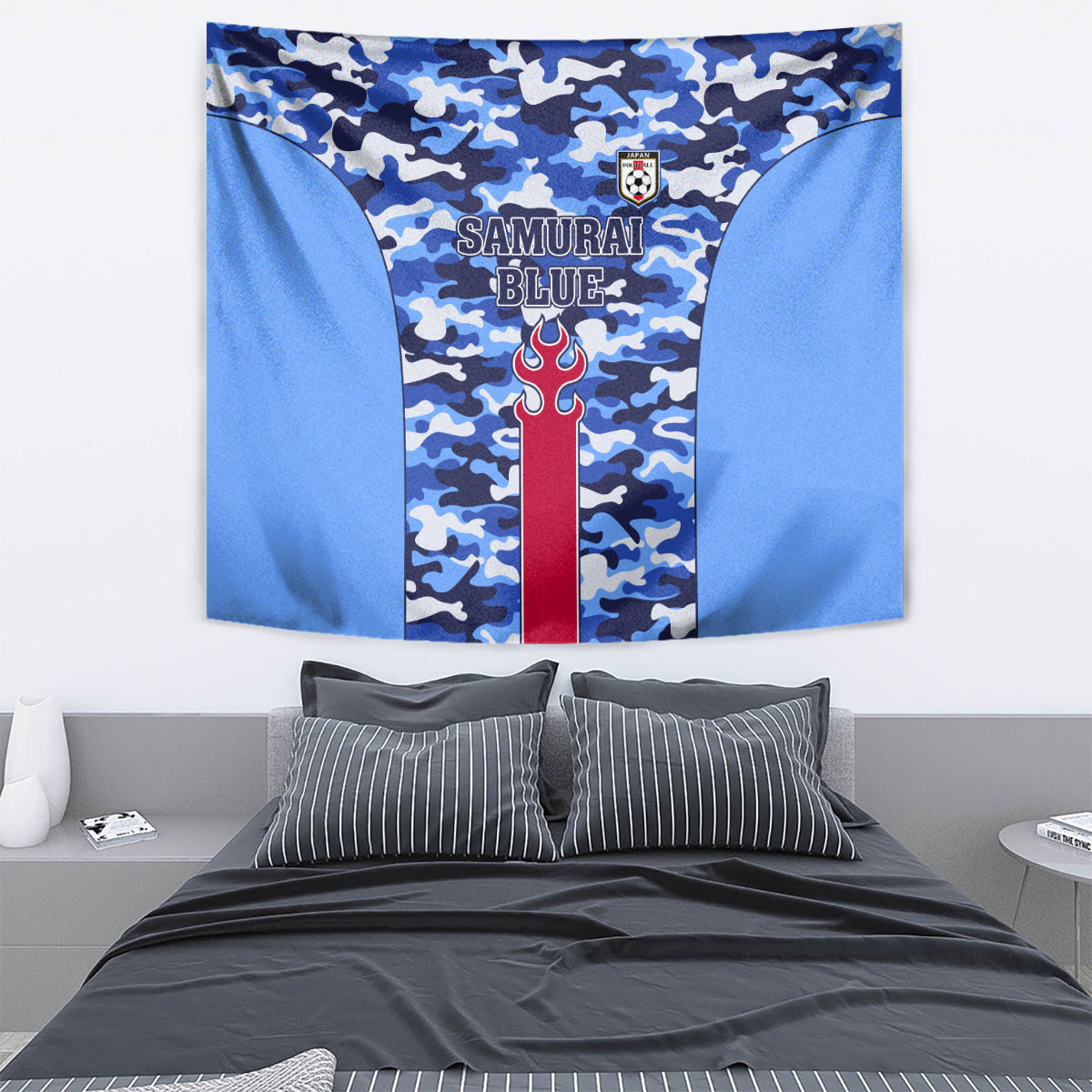 Close-up blue camouflage tapestry with SAMURAI BLUE text, red flame emblem, crest