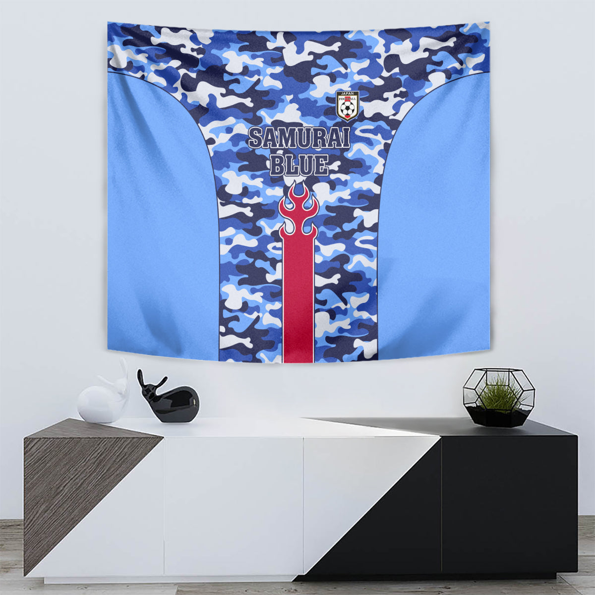 Blue camouflage tapestry featuring central red flame emblem with crest and banner text