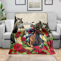 Racing blanket draped over gray sofa, showing Kentucky Derby horse and rose design in color