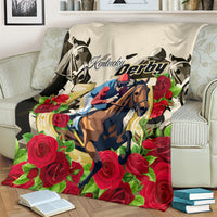 Kentucky Derby horse and rose-themed blanket spread on cream sofa with vivid red floral border