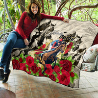 White quilt featuring Kentucky Derby horse and red roses, shown folded on patio